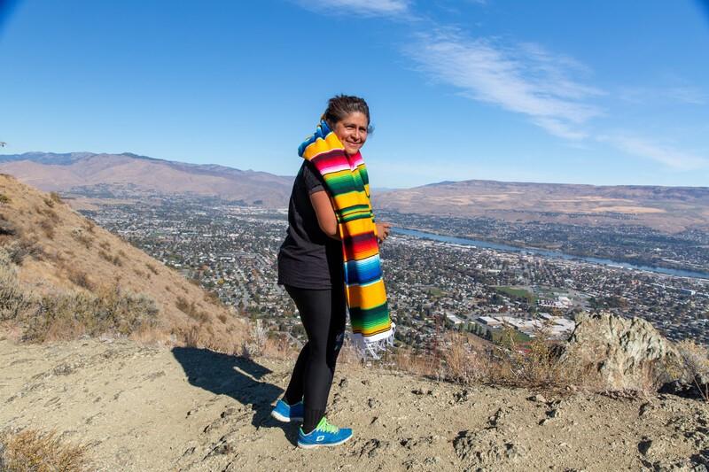 Teresa Zepeda Sosa stands in front of a vista of Wenatchee, Washington