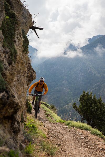 A man riding a mountain bike on a rocky trail.
