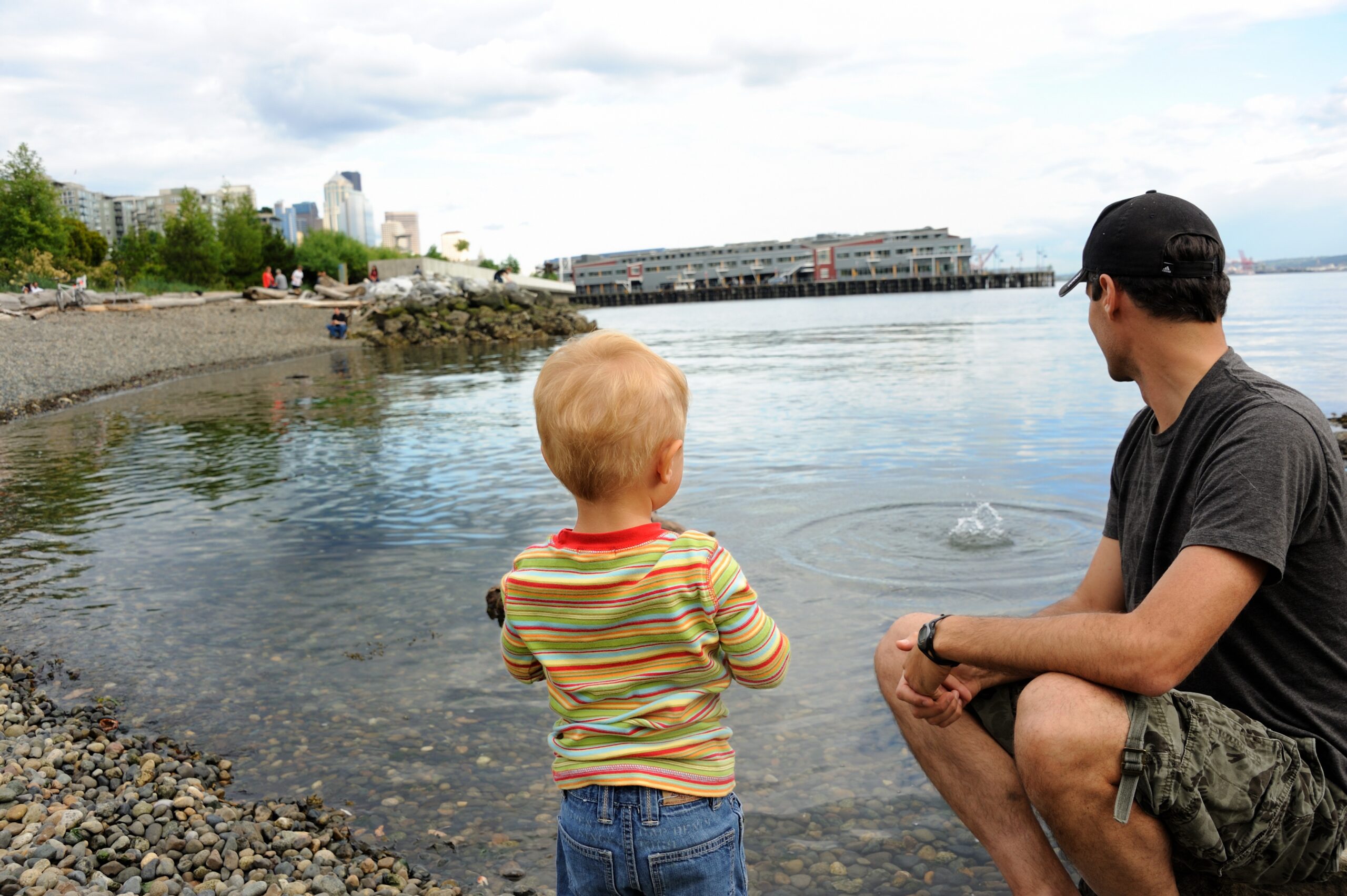 A man and a child watching the water.