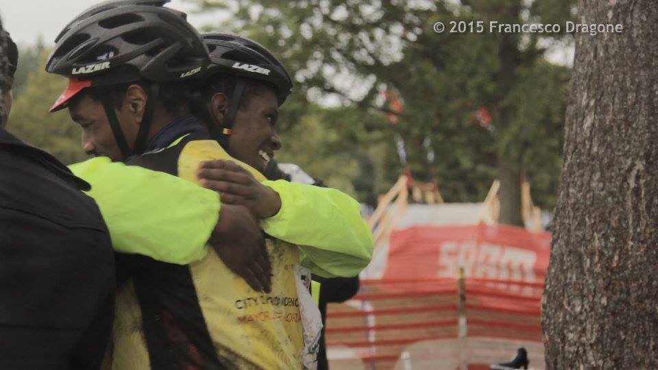 Two bike racers hug