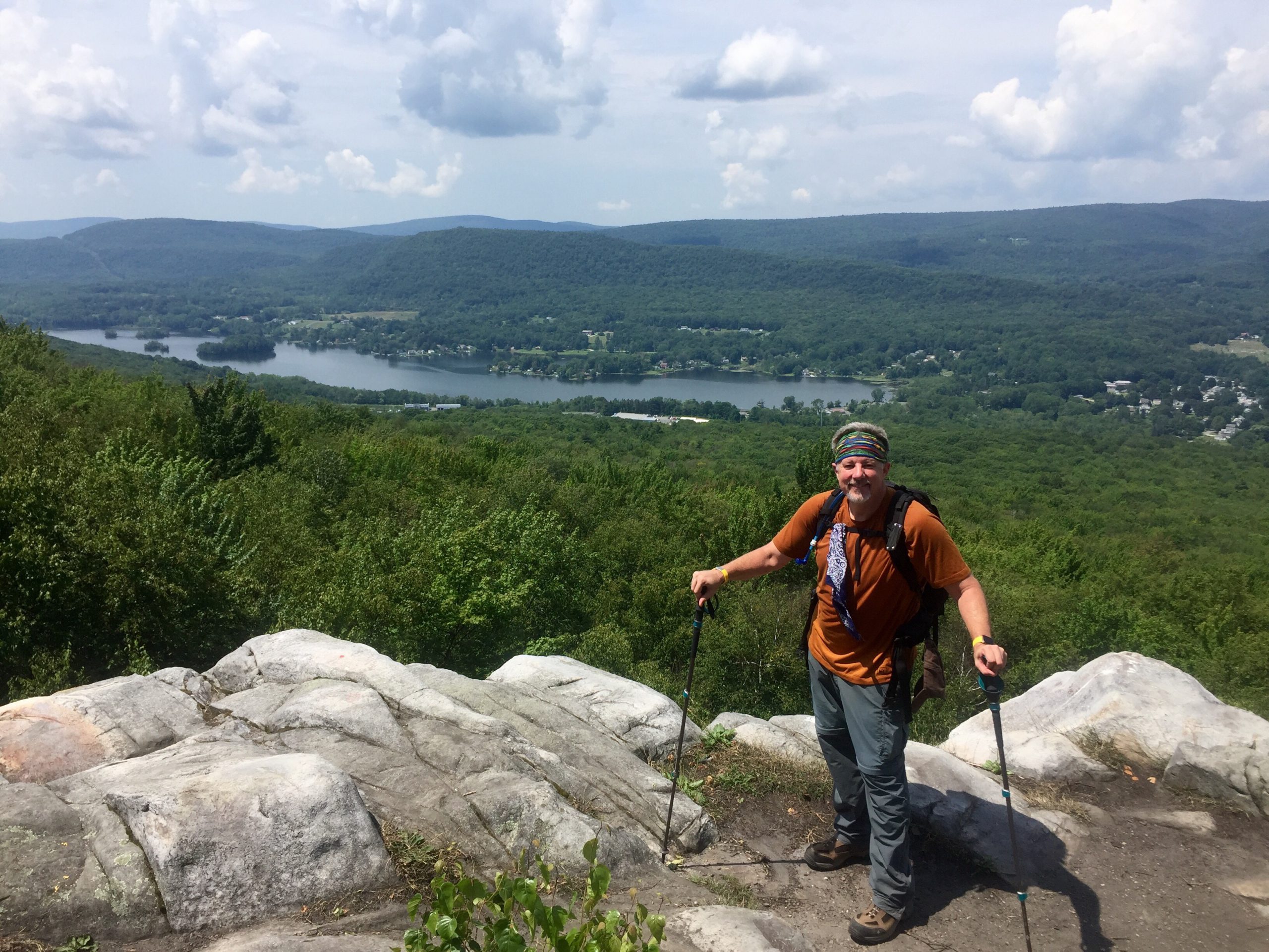 A man poses at a trail lookout