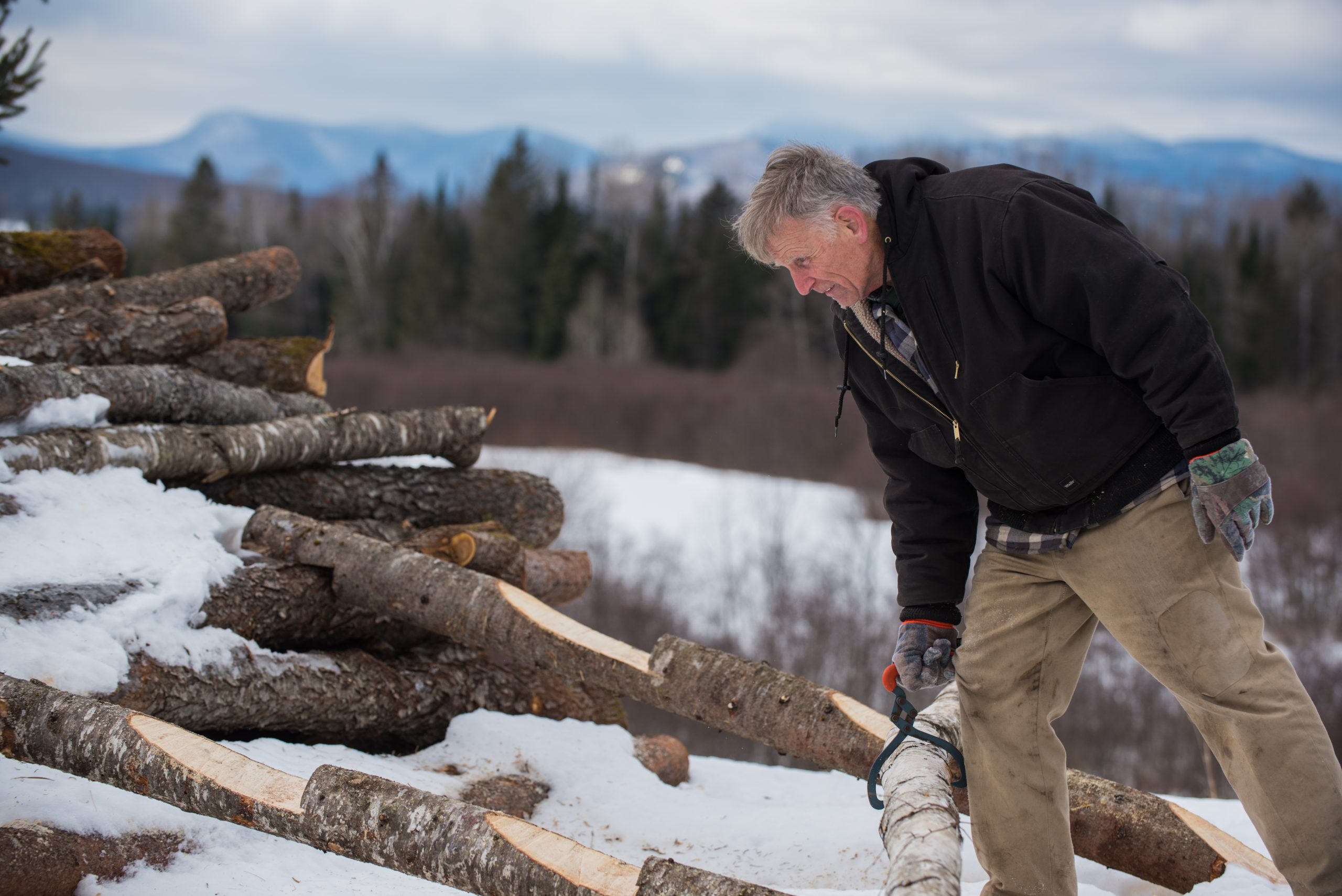 Rick Alger with a pile of logs