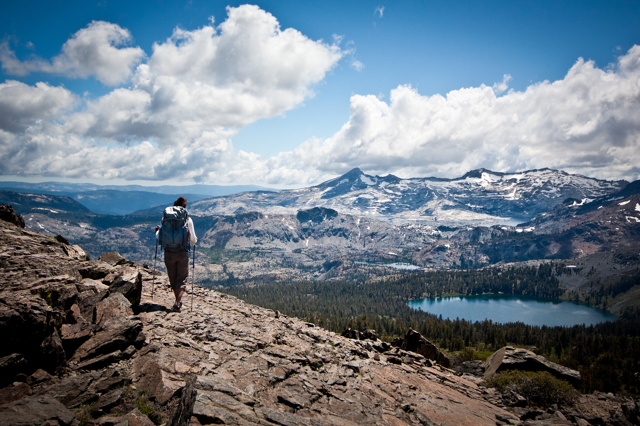 A hiker looks over a high mountain vista