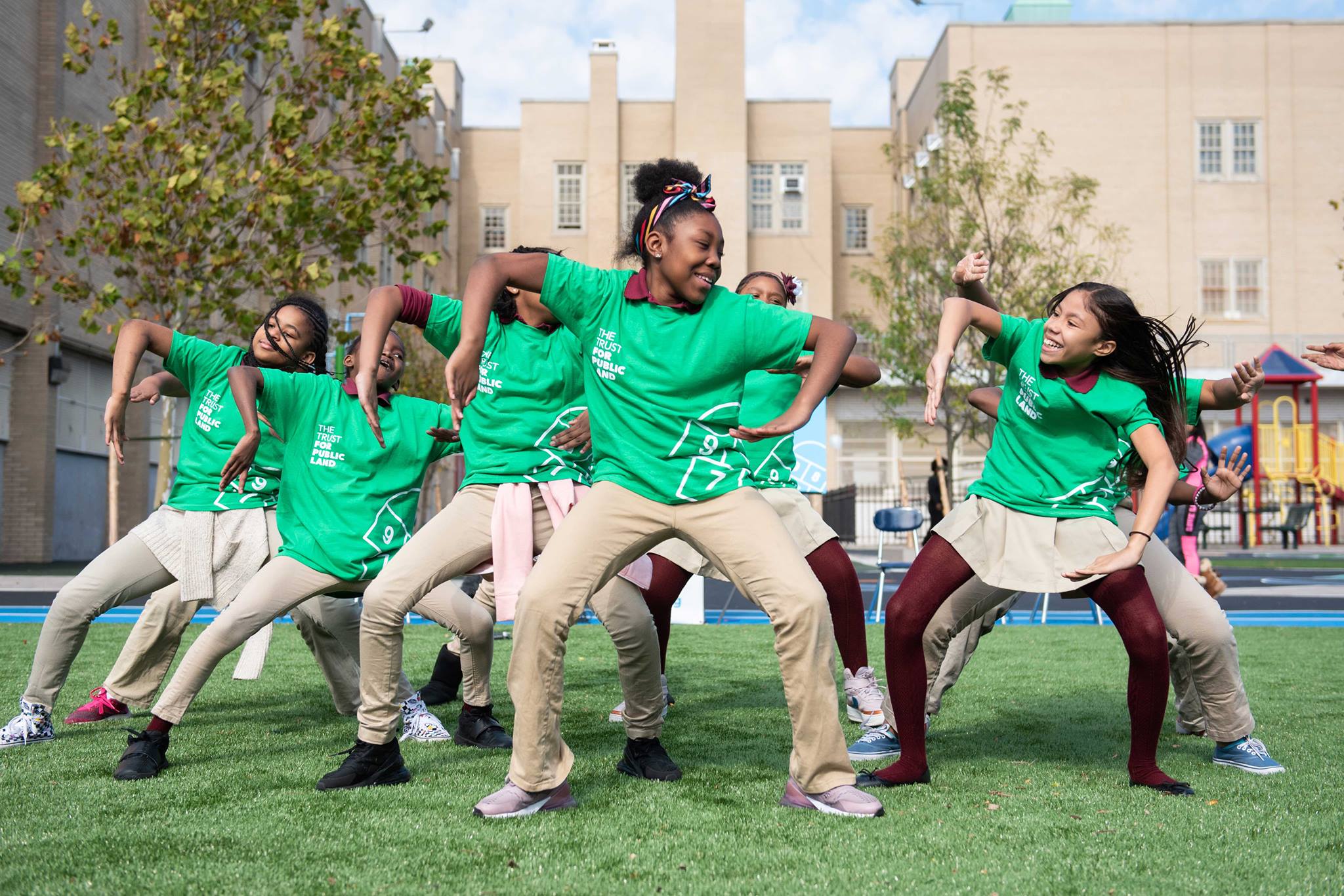 Students dance on a playground