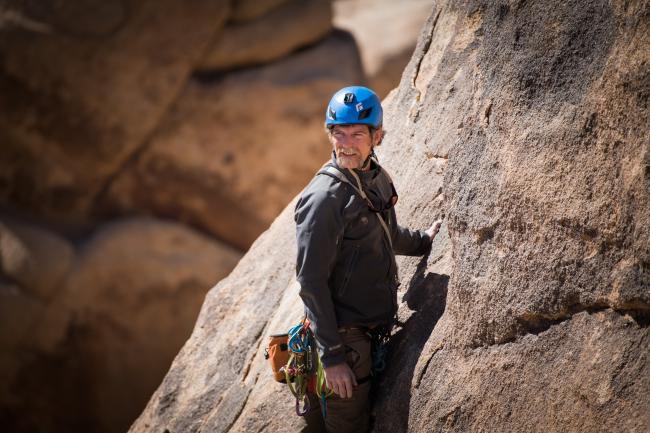 A man climbs a rock cliff