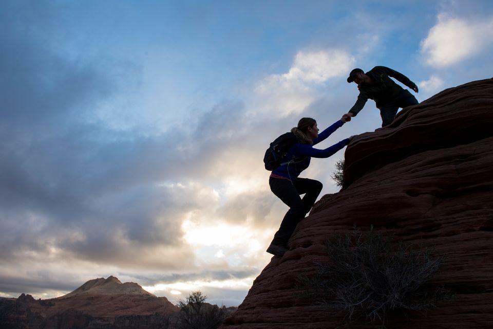 Hikers helping each other near Tabernacle Dome on the Kolob Terrace in Zion National Park.