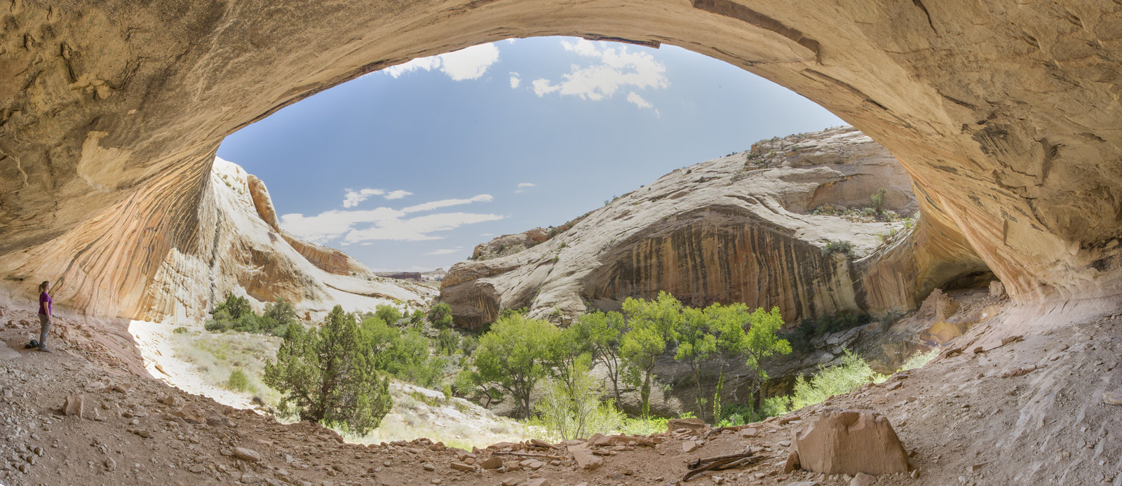 A person stands under an arch at Bears Ears National Monument