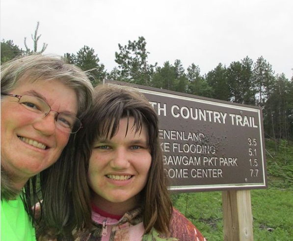 Laurie and Andrea Kass take a selfie by a North Country Trail sign