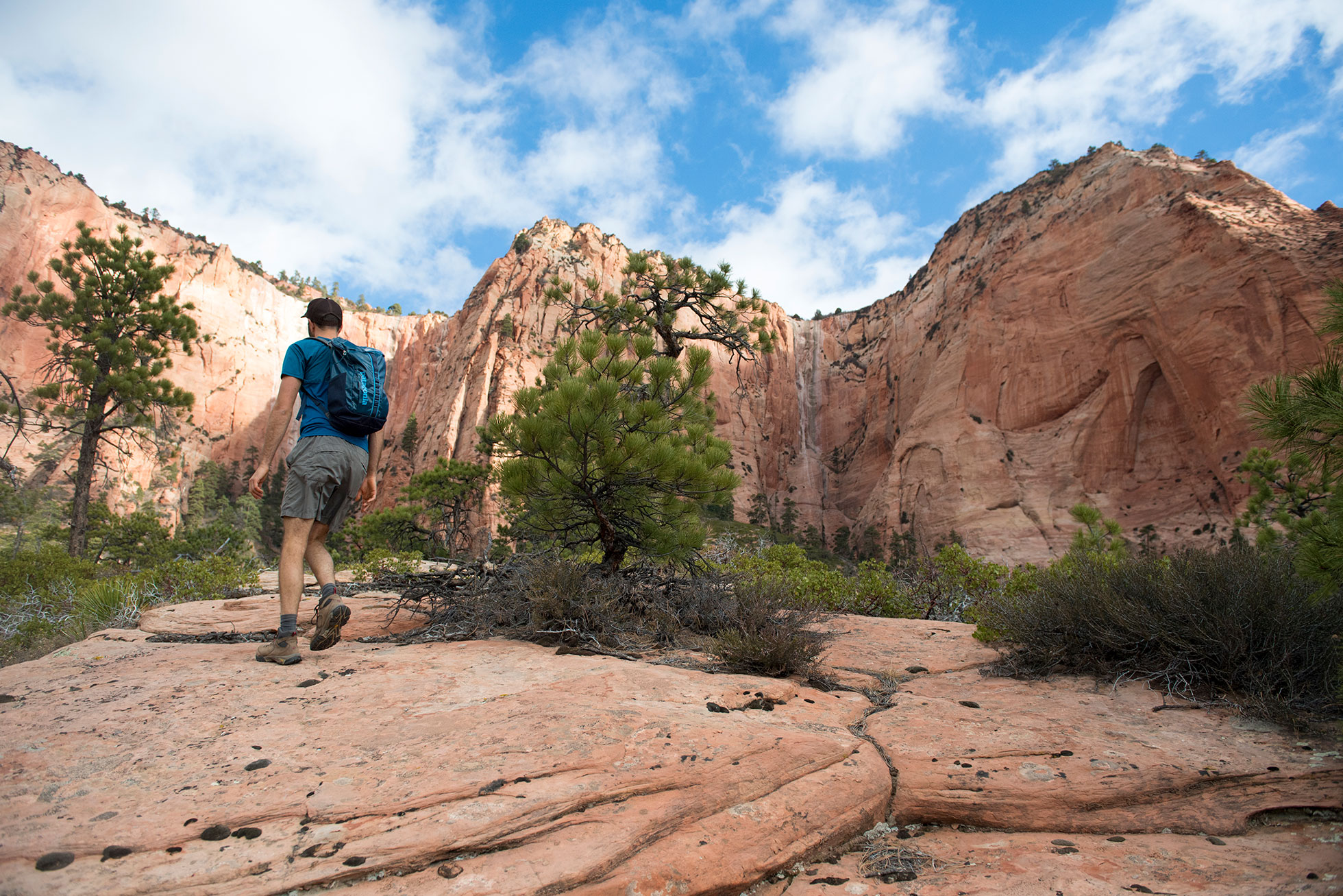 A man hiking through a canyon.