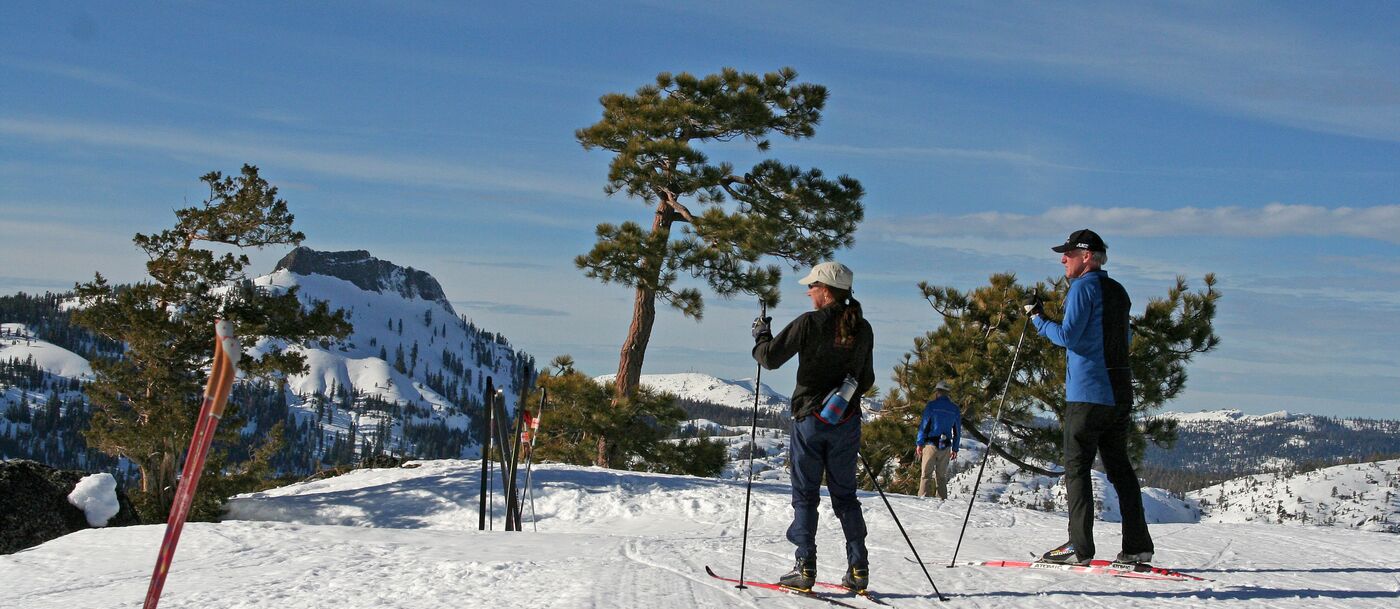 Two people on skis on a snowy slope.