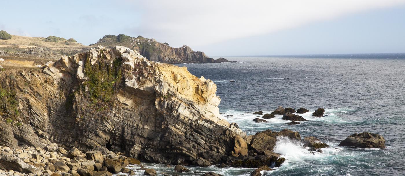 A rocky cliff overlooking the ocean.