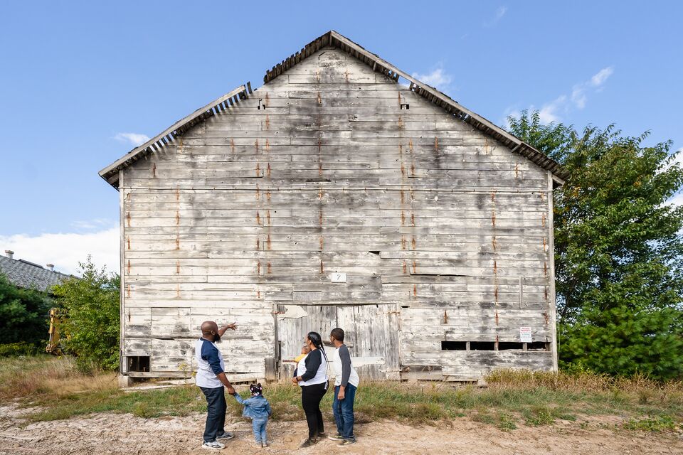 A family outside a historic barn in Simsbury, Connecticut