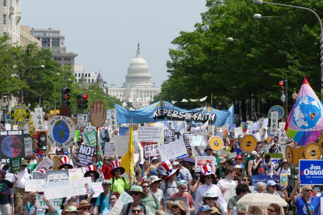People march for climate in front of the US Capitol Building