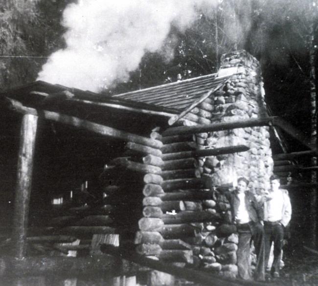 Jim and his brother Bob at the cabin they built near the Raging River in the 1930s.