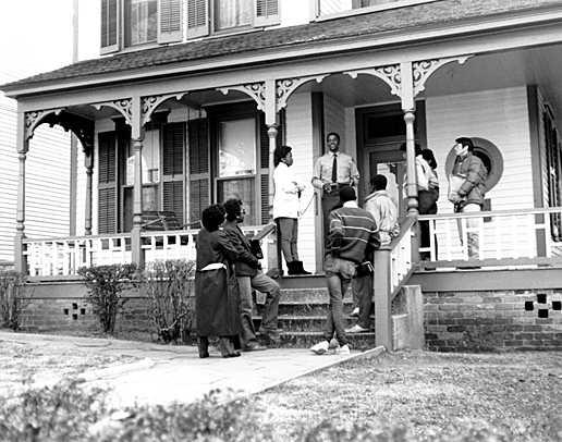 A park ranger on the porch of MLK's birthhome with visitors