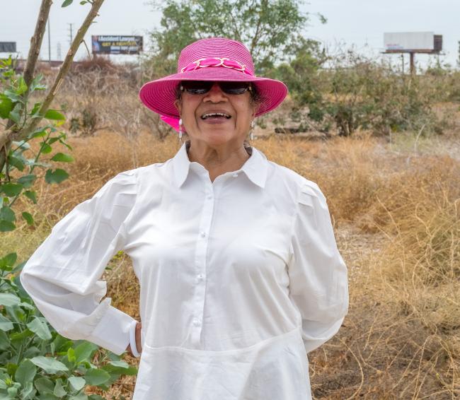 Rosa Rodriguez poses for the camera at the site of the future Urban Orchard in South Gate, California