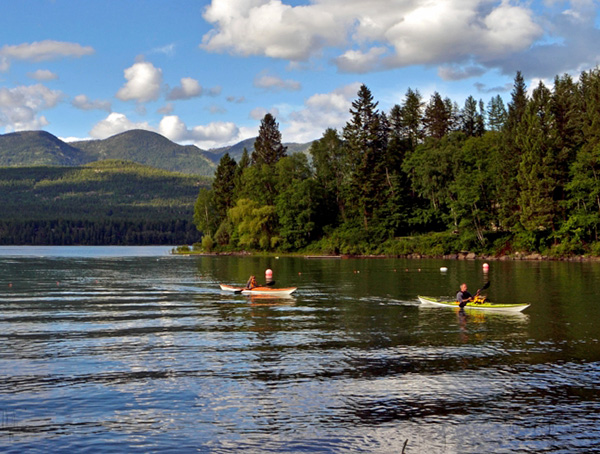 A group of people kayaking on a lake.