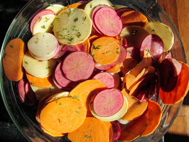 a bowl of sliced colorful root vegetables