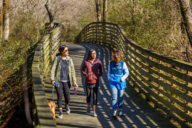Three women hike South Chickamauga Creek Greenway Chattanooga, Tennessee.