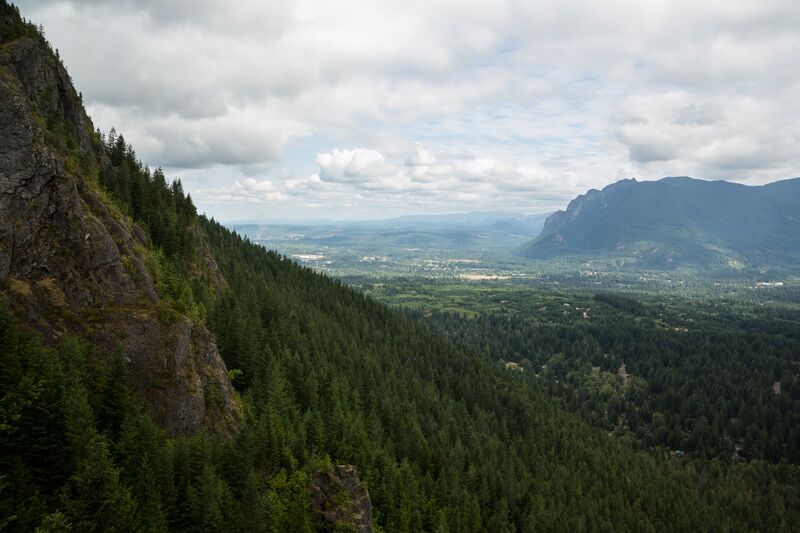 A view from the top of a cliff overlooking a valley.