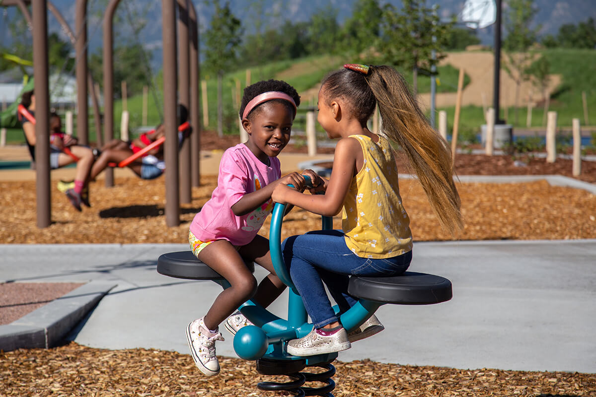 Two girls play on playground equipment at the newly renovated Panorama Park.
