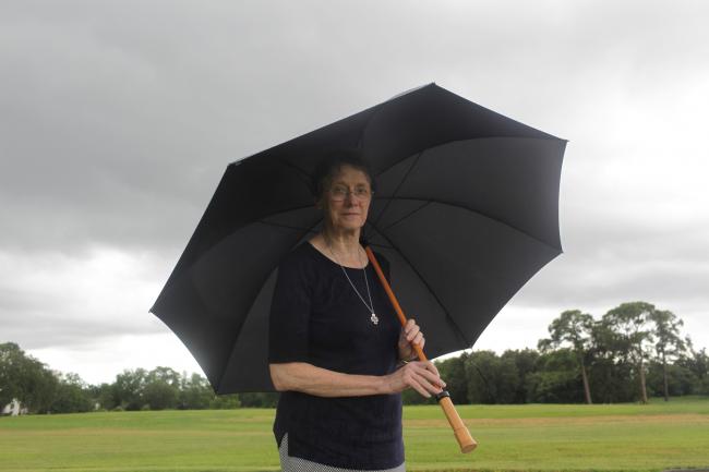 A woman holds an umbrella