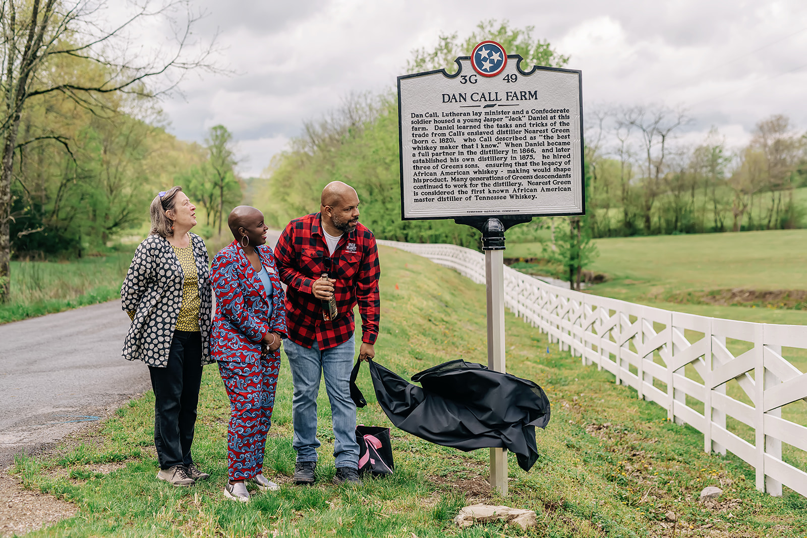 TPL President Diane Regas, Black History and Culture Director Jocelyn Imani stand next to and Board Member Keith Weaver as he unveils a roadside marker for the historic Dan Call Farm in Tennessee.